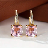 Goldene Ohrringe mit mystischem Steinkreis – Pink-Saphir