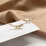 Yazaria – Ohrringe mit Blumenmuster – Gold