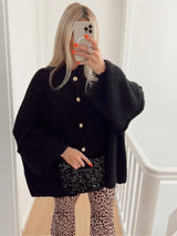 Bequeme Strickjacke mit Geripptem Ausschnitt – Schwarz