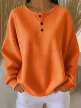 Damen nan Oversized Waffelstrick Henley-Pullover mit Knopfleiste und abgerundetem Saum Drune – Orange