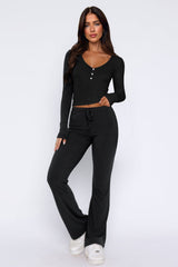 Laureen | Ausgestellter Jumpsuit mit langen Ärmeln – Schwarz