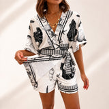 Azzurine™ Skort-Jumpsuit Mit Wickeloptik, Seitlicher Bindung Und Exklusivem Mediterranem Print – Schwarz