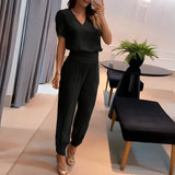 Zweiteiliges Set aus Damenbluse und gemusterter Hose – Schwarz